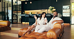 Couple, laugh and talk on sofa in home with funny story, gossip or together with memory in living room. Mature people, man and woman with interracial love with joke, happy and relax on valentines day