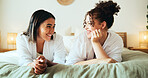 Sleepover, happy friends and girls relax in bedroom for bonding, talk or gossip story. Bed, women and together in luxury hotel for rest, holiday or communication at slumber party for social hangout