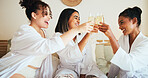 Women, friends and toast drinks at spa, bed and happy for reunion, bonding and diversity at resort. People, girl and group with champagne, glass or celebration with alcohol in hotel room on holiday
