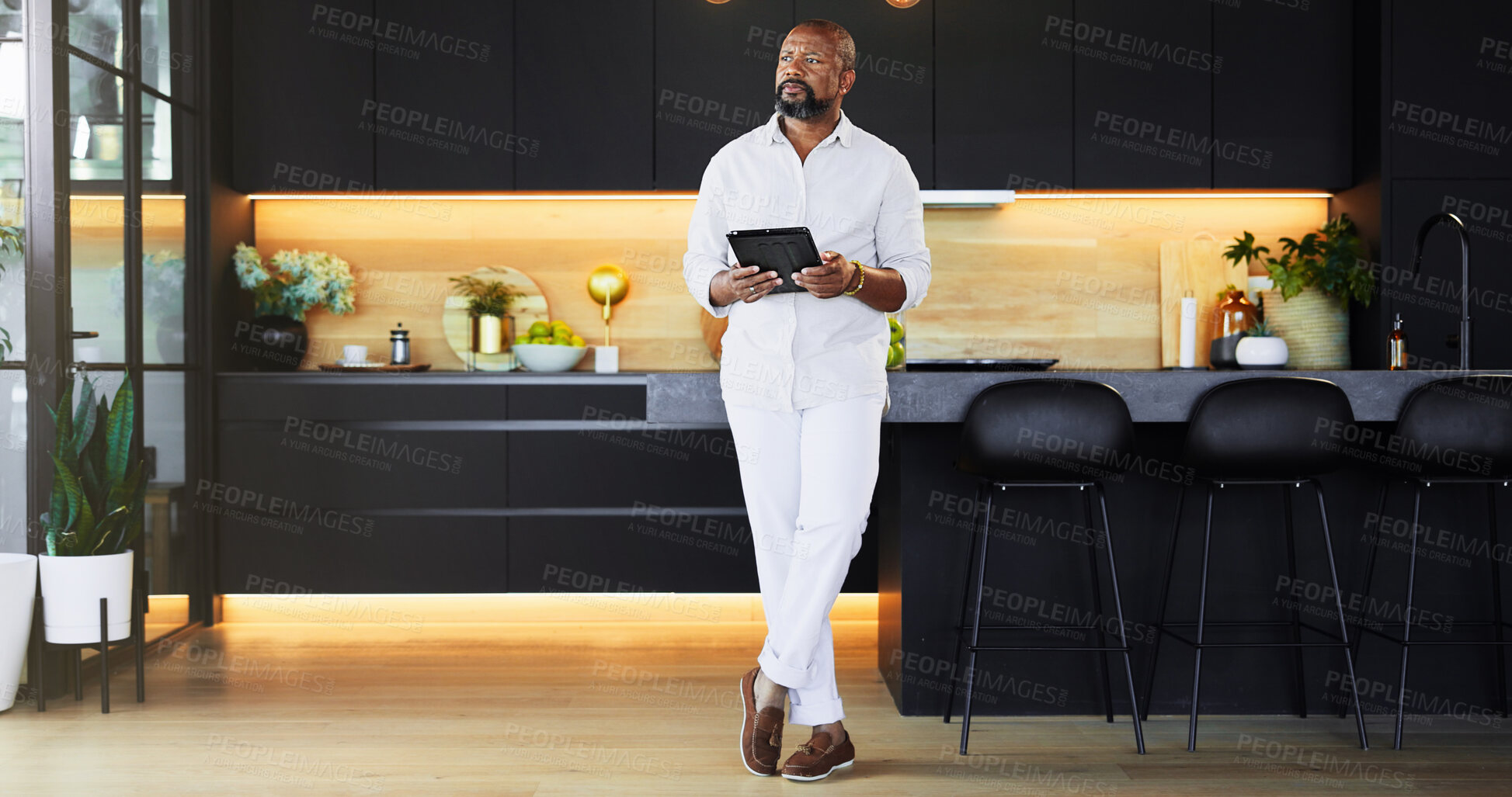 Buy stock photo Kitchen, tablet and thinking with black man in home as realtor to search for interior design ideas. Future, planning and vision with serious mature person in apartment for property or real estate