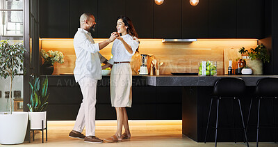Buy stock photo Happy, interracial couple or holding hands with dance in kitchen for romance, love or bonding together at home. Man, woman or lovers with smile or support for weekend, sway or romantic steps at house