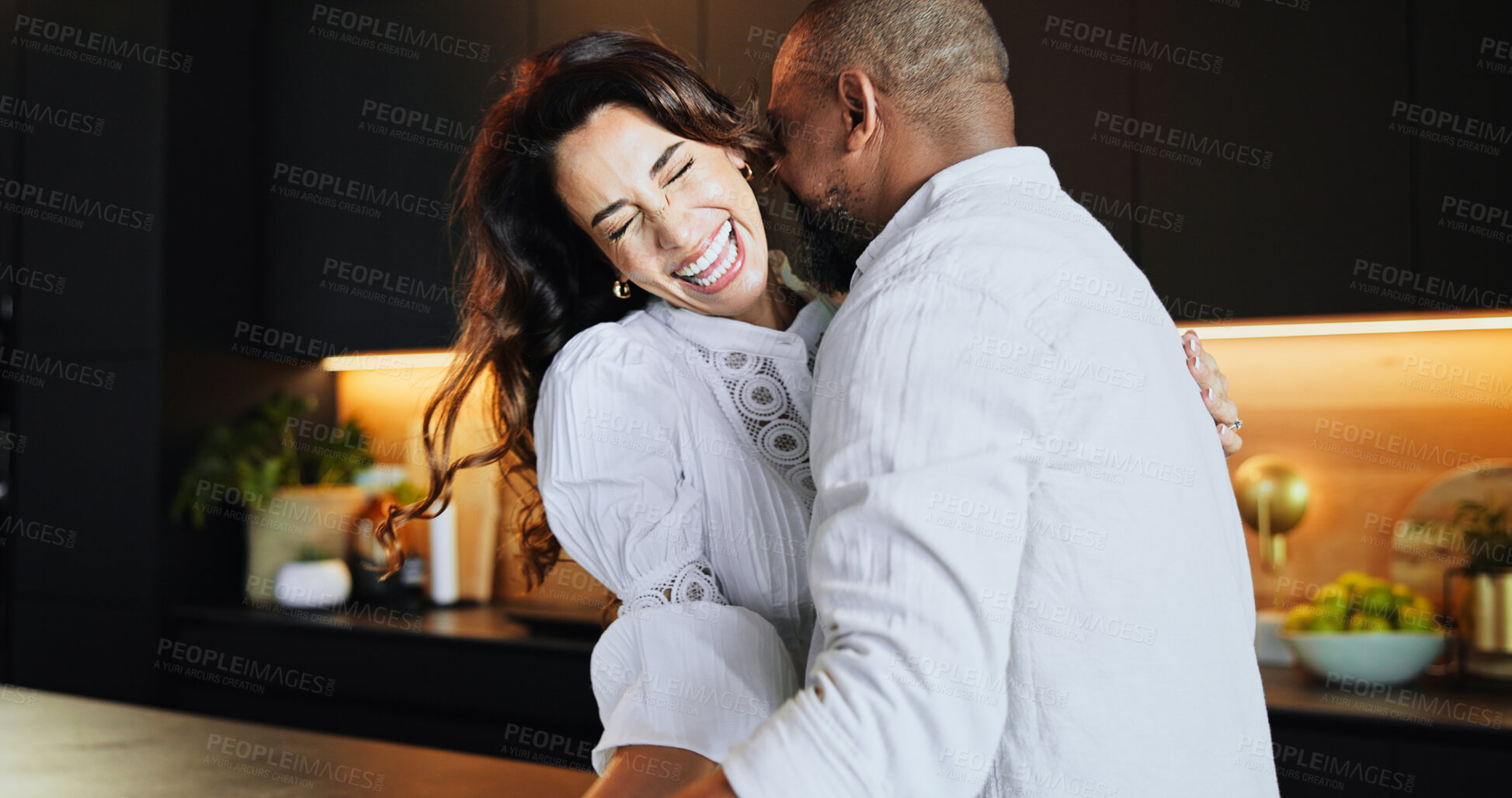 Buy stock photo Care, dance and laugh with interracial couple in kitchen for bonding, connection and romance. Happiness, support and love with man and woman at home for commitment, marriage and valentines day