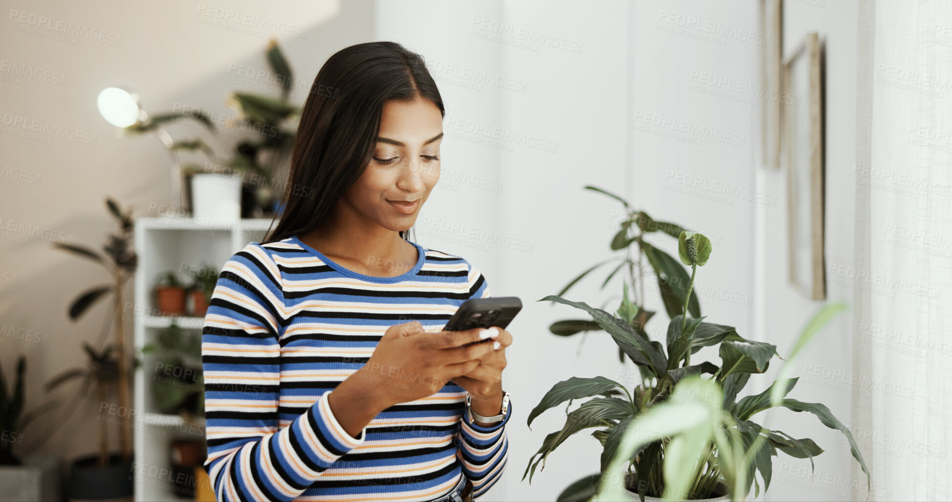 Buy stock photo Phone, home and Indian woman with online application, social media and college portal. Message, plants and girl student on mobile for university website, scholarship and communication in living room