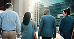 Building, commute and collaboration with business people in city together for travel to work. Back, direction or group with man and woman corporate employees walking outdoor in urban town for journey