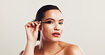 Woman, portrait and beauty with eye lashes for makeup, cosmetics or mascara on a white studio background. Female person, tool and filler with stick for volume, curl or color thickness on mockup space