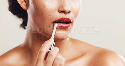 Buy stock photo Lip gloss, shine and makeup with closeup of woman in studio for beauty product, self care and cosmetics. Lips, aesthetic and salon with person on white background for glow, treatment and glamour.