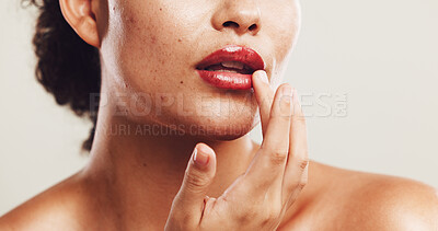 Buy stock photo Lips, shine and makeup with hand of woman in studio for beauty product, self care and cosmetics. Closeup, aesthetic and salon with person on white background for glow, spa treatment and mouth