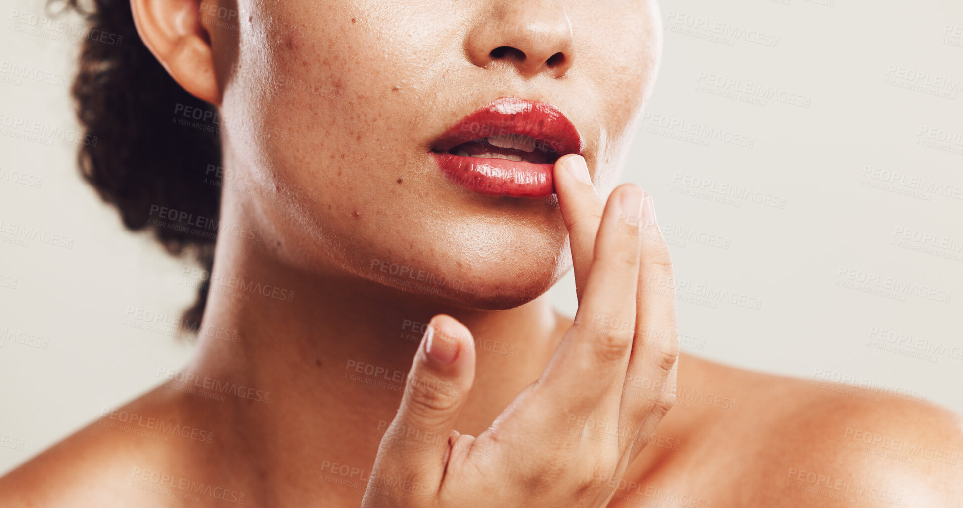 Buy stock photo Lips, shine and makeup with hand of woman in studio for beauty product, self care and cosmetics. Closeup, aesthetic and salon with person on white background for glow, spa treatment and mouth