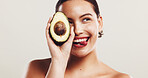 Avocado, skincare and woman in studio with collagen organic and natural face routine. Beauty, dermatology and female person with fruit for facial moisturizing treatment with glow by white background.