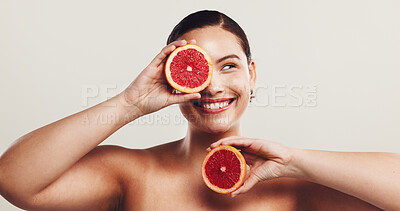Buy stock photo Skincare, woman and happy with grapefruit in studio for skin hydration, retinol antioxidants and anti aging. Space, natural beauty and girl with fruit for pigmentation reduction on white background