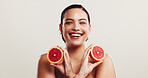 Skincare, girl and portrait with grapefruit in studio for healthy skin, collagen production and antioxidants. Space, natural beauty and woman with fruit for acne treatment or glow on white background