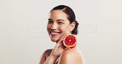 Buy stock photo Skincare, woman and portrait with grapefruit in studio for skin hydration, collagen production and vitamin C. Space, natural beauty and girl with fruit for pigmentation reduction on white background