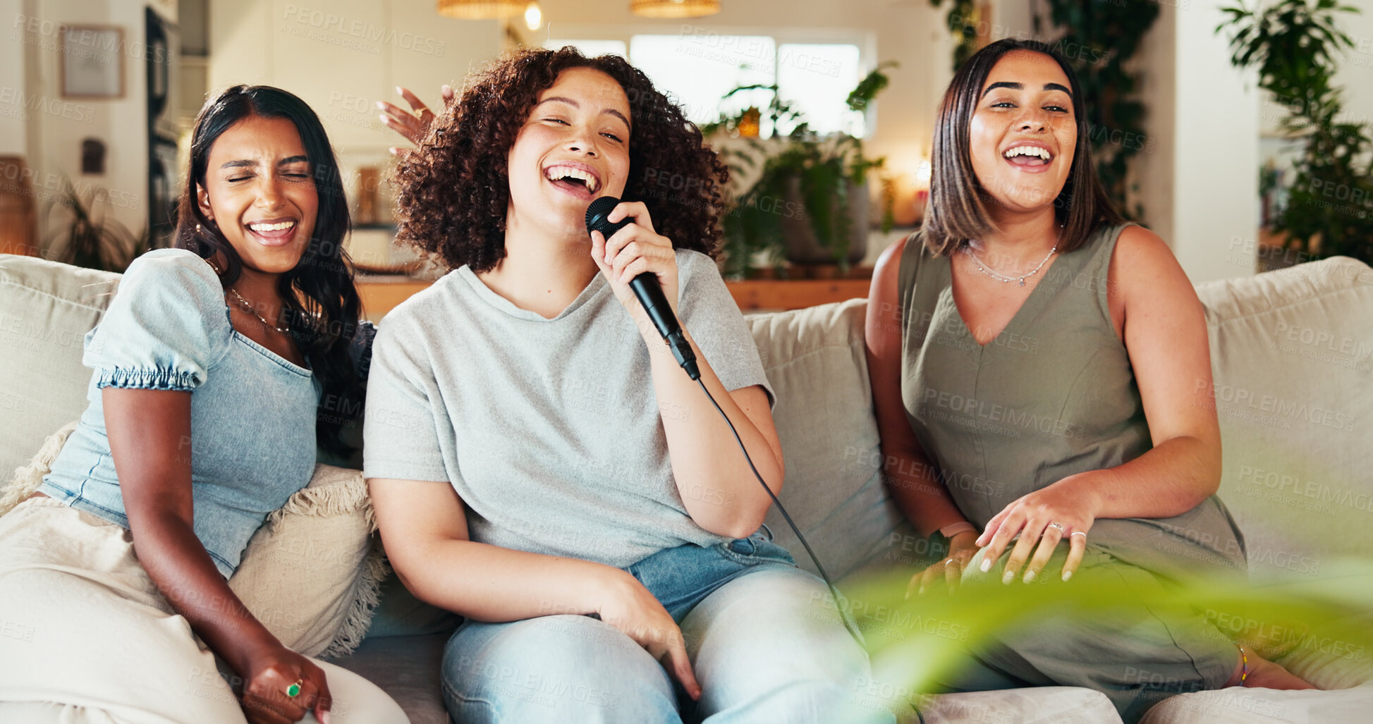 Buy stock photo Karaoke, friends and women singing on living room sofa with microphone for music, playlist or radio. Reunion, party and people with energy, song and having fun together for bonding in home lounge
