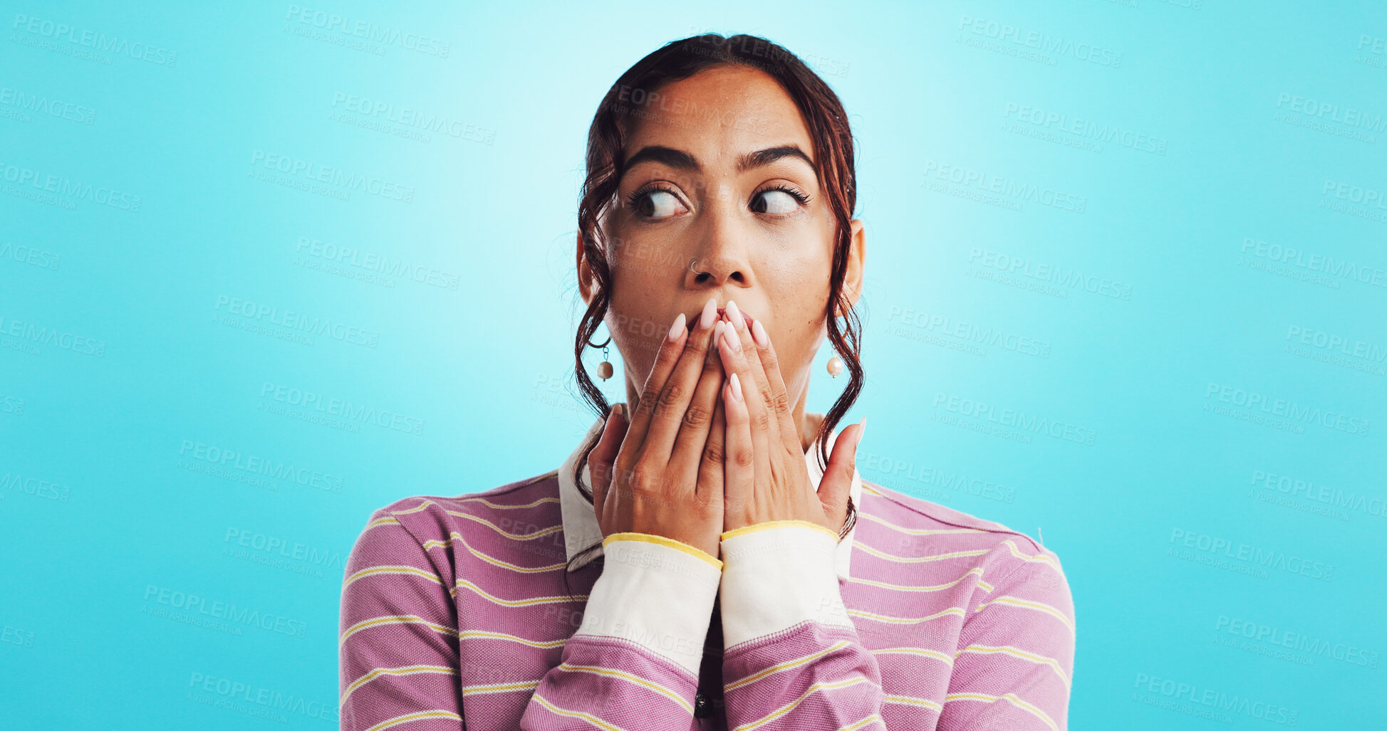 Buy stock photo Woman, surprise and hands for announcement in studio, hearing gossip and overwhelmed with information. Blue background, shock and reaction to confidential secret, person and cover mouth for story