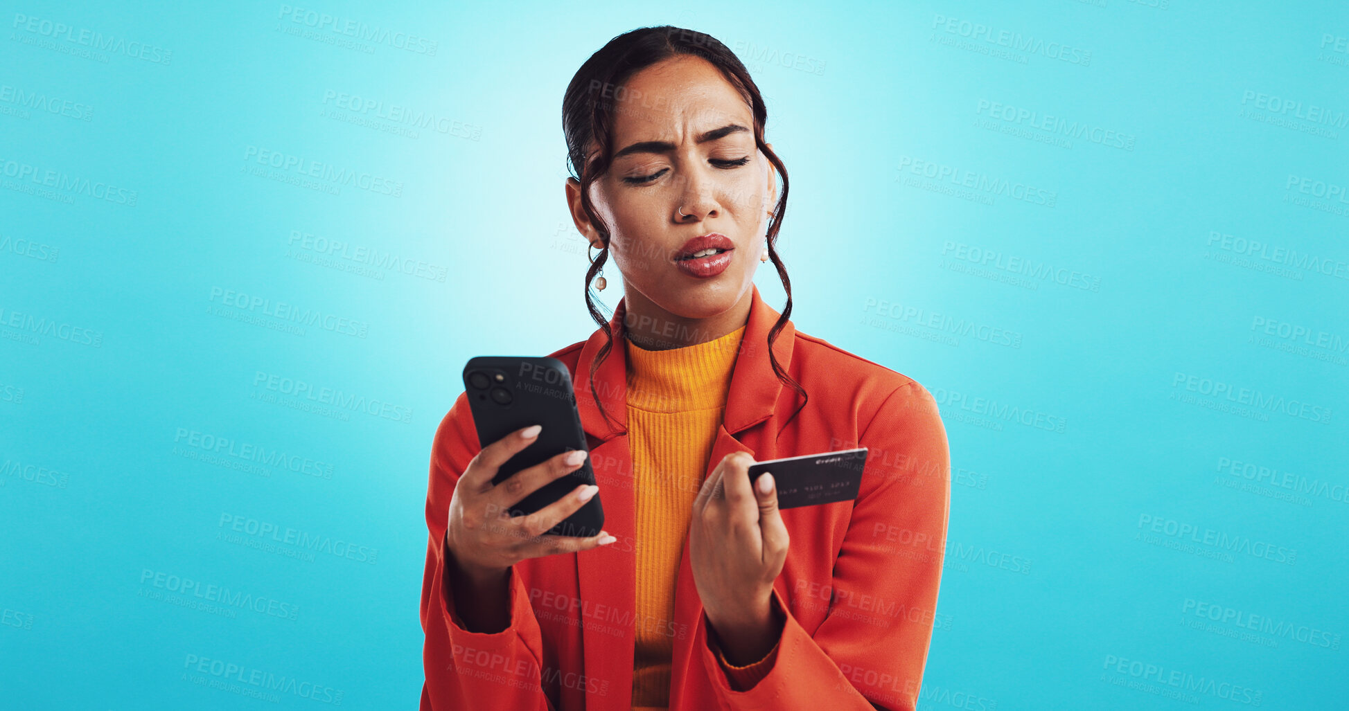 Buy stock photo Credit card, confused and woman in studio, smartphone and girl with doubt on blue background. Person, mobile app and model with cellphone, fail and mistake with online banking, scam and error