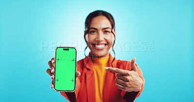 Buy stock photo Green screen, phone and pointing with portrait of woman in studio for advertising or marketing. Mockup, notification and promotion with happy person on blue background for announcement or news