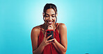 Girl, phone and texting on valentines day in studio with smile, chat or online dating by blue background. Woman, smartphone and happy in red dress with mobile app, excited and contact on social media