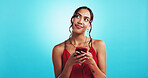 Girl, phone and red dress on valentines day in studio with smile, chat or mockup space by blue background. Woman, smartphone and happy for texting date on app, thinking and contact on social media