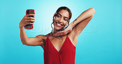 Buy stock photo Woman, selfie and happy for valentines day in studio, excited or photography in red dress by blue background. Girl, influencer and smile with profile picture, app and live streaming on social network