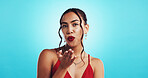 Portrait, red lips and woman with kiss, blowing and flirting with date on valentines day and romance. Mockup space, blue background and person with lipstick for event, studio and love for anniversary