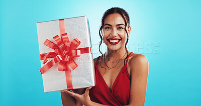 Buy stock photo Woman, gift and smile for valentines day in studio portrait with celebration for romance by blue background. Girl, person and excited for love with box, present and red dress for date in Colombia