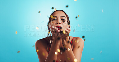 Buy stock photo Woman, blowing kiss and glitter in studio, valentines day celebration and blue background. Portrait, special announcement and sparkle confetti for party or event, decoration and winning aesthetic