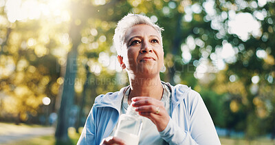 Buy stock photo Fitness, senior woman and drinking water at park for exercise break, running fatigue or resting from jog. Detox, runner or liquid bottle for wellness, retirement cardio or marathon training in nature