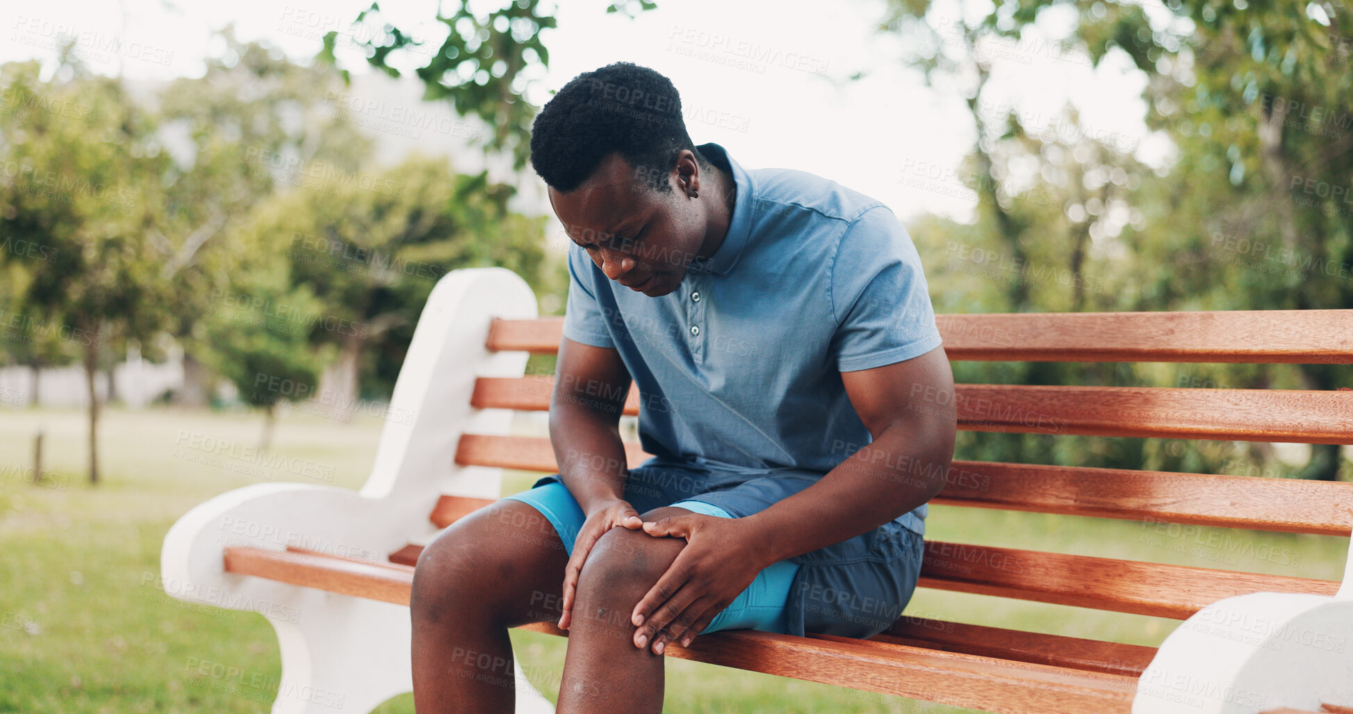 Buy stock photo Knee pain, fitness and black man in park with injury, muscle strain and joint inflammation on bench. Nature, sports and person with accident for exercise, workout and training outdoors for health