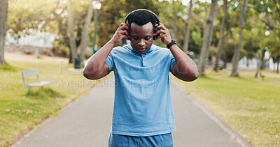 Buy stock photo Headphones, music or black man in park for running, training exercise or workout for fitness. Outdoor, African athlete and healthy male runner listening to sports podcast, motivation or radio audio