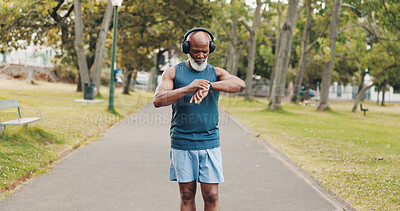 Buy stock photo Park, man and smart watch for fitness music, exercise steps or training performance. Outdoor, sport or African athlete with wristwatch for workout time, senior wellness or body health with headphones