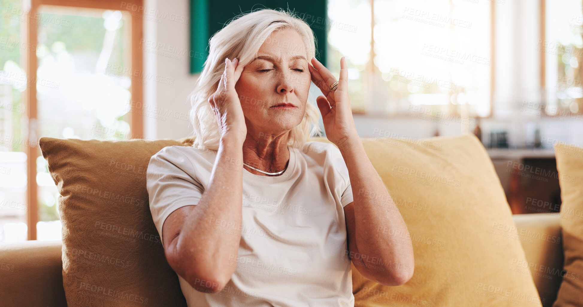 Buy stock photo Headache, massage and stress with senior woman on sofa in living room of apartment for pain relief. Burnout, migraine and temple with old person in retirement home for health, rest or wellness