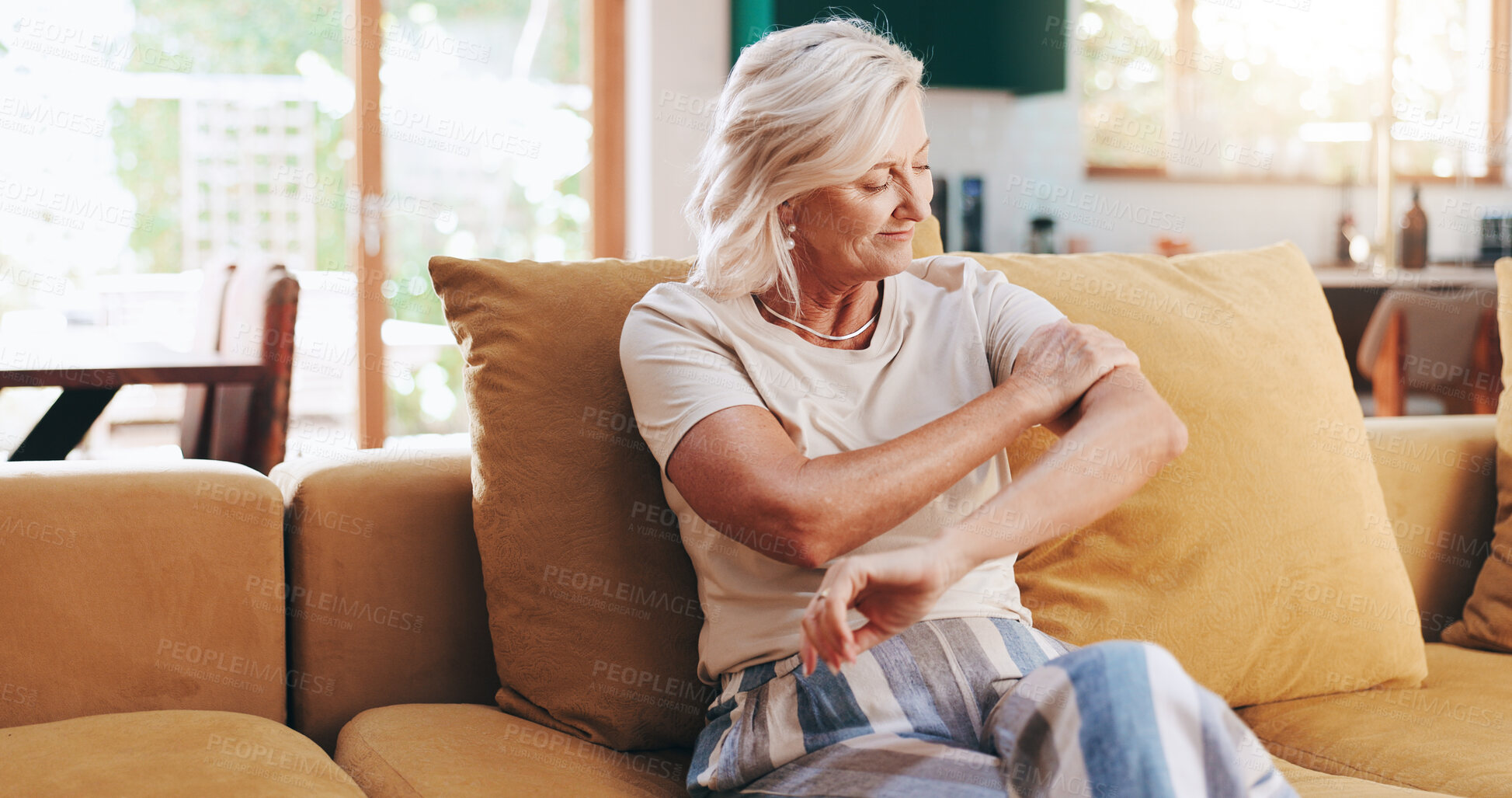 Buy stock photo Recovery, calm and senior woman in home, living room or smile for healing of arthritis joints or muscle. Lounge, physical therapy and treatment for improved mobility, happy or rehabilitation in house