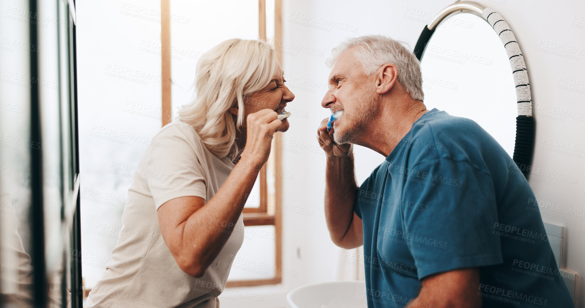 Buy stock photo Cleaning, senior couple and brushing teeth for hygiene, smile or routine for prevention of cavity. House, elderly people and toothbrush for oral health in bathroom, happy or together with dental care