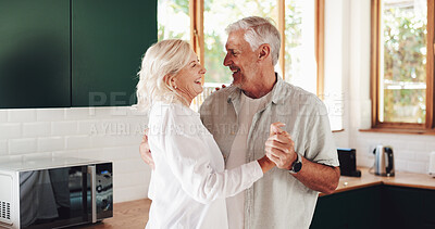 Buy stock photo Senior couple, laughing and dancing in home, love and enjoy holding hands with happy wife in kitchen. Elderly people, smile and support by listening for healthy marriage, funny joke and retirement