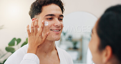 Buy stock photo Home, couple and happy with cream for skincare, wellness and hydration benefits in morning. House, man and woman with application for cosmetics, beauty treatment and support with moisturizer for face