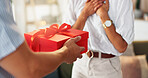 Love, gift and box with hands of couple for valentines day celebration, romance or bonding. Relationship, care and surprise with man and woman at home for support, connection or present together