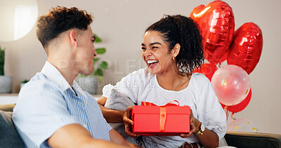 Buy stock photo Love, gift and smile with couple on sofa for valentines day celebration, box or bonding. Relationship, balloons and romance with man and woman at home for support, connection or present together