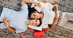 Love, gift and above of couple on floor for valentines day, romance and bonding. Relationship, flower petals and happiness with man and woman in living room of home for support, connection and relax