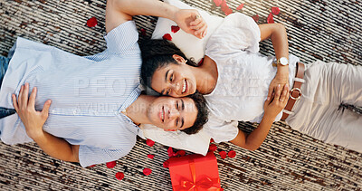 Buy stock photo Love, gift and above of couple on floor for valentines day, romance and bonding. Relationship, flower petals and happiness with man and woman in living room of home for support, connection and relax