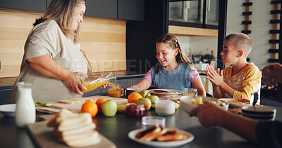 Buy stock photo Mother, children and serving breakfast in kitchen with healthy food, pouring juice and eating together. Happy family, woman and kids with lunch meal in home for wellness, hunger support and bonding