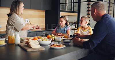 Buy stock photo Parents, kids and serving breakfast in kitchen with healthy nutrition, sandwich food and eating together. Happy family, people and lunch meal in home for wellness, bonding and relationship by table