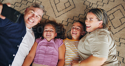 Buy stock photo Selfie, happy and above of parents with children for memory, profile picture and social media post. Family, home and mom, dad and kids take photo on floor for bonding, love and relax in living room