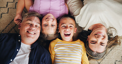 Buy stock photo Above, parents and children with portrait on floor for bonding together, support and security. Happy family, people and relax in home with love relationship, protection and laughing on carpet for fun