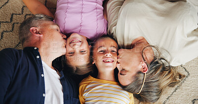 Buy stock photo Love, parents and kiss children on floor for bonding together, support and security with affection. Top view, people or relax in home with relationship, protection or happy on carpet with fun weekend