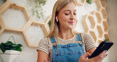 Buy stock photo Sustainable business, smile and woman with smartphone, office and watching reviews on social media. Floral shop, entrepreneur and person with earphones for videos, online and happy with ratings