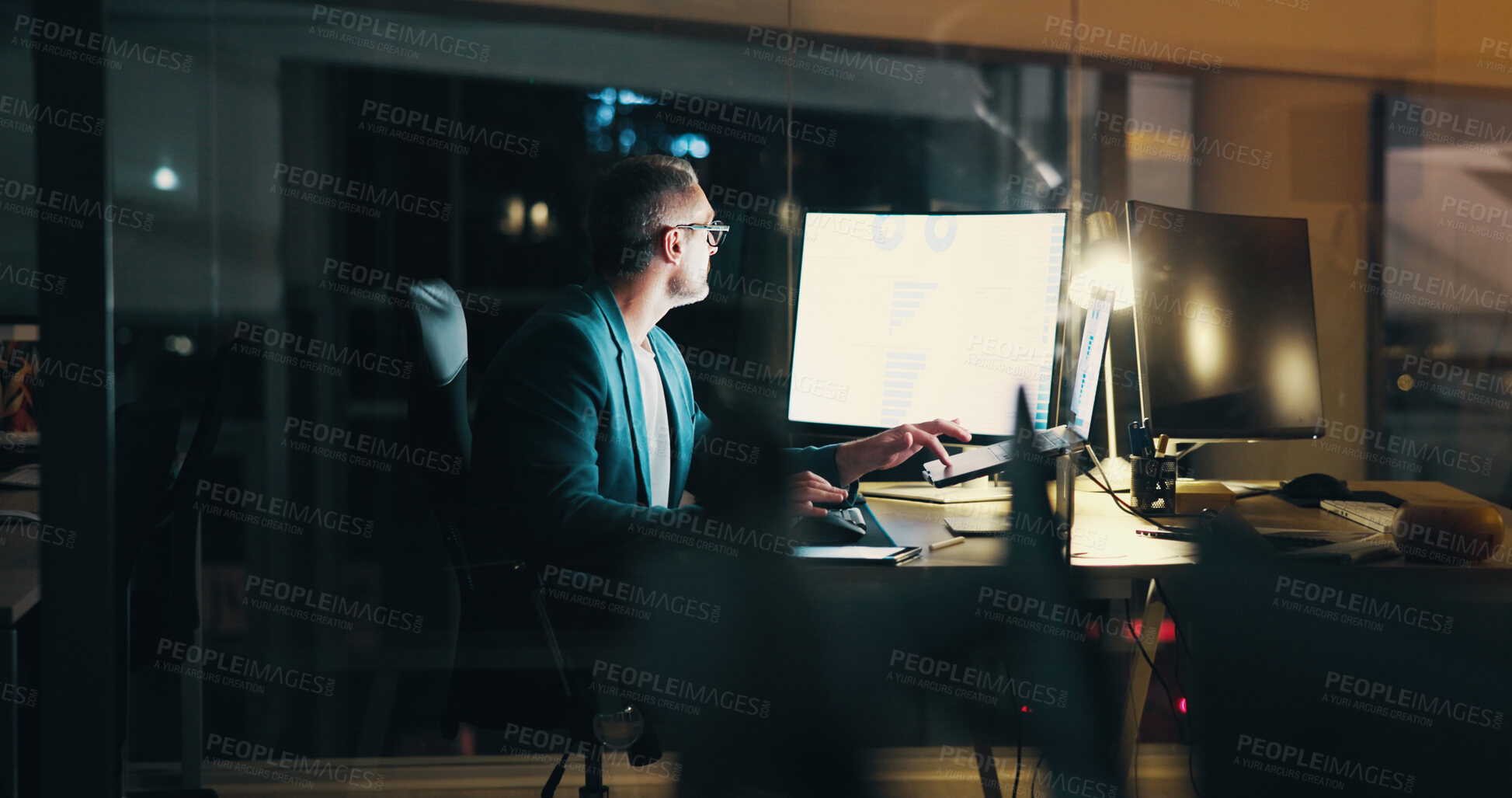 Buy stock photo Dark office, computer and mature businessman at night with statistics for finance report, research and analytics. Corporate, company and person working late for financial planning, review and fintech