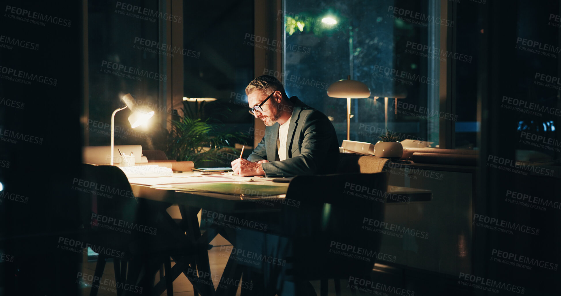 Buy stock photo Architecture, night and business man in office for urban planning, property design and floorplan. Creative agency, working late and architect with layout, blueprint and paperwork for building project