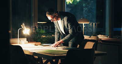 Buy stock photo Architecture, night and man in office with blueprint for urban planning, property design and floorplan. Creative agency, working late and architect with layout, drawing and paperwork for project