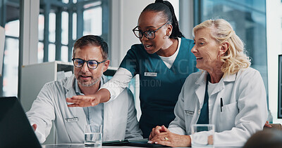 Buy stock photo Hospital, pointing and doctors on laptop in meeting for consulting, teamwork and medical advice. Healthcare, clinic and man with women on digital tech in collaboration, research or telehealth website