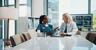 Buy stock photo Discussion, doctor and medical student in hospital with xray for surgery planning in collaboration. Women, conversation and mature surgeon with healthcare intern for teaching treatment with MRI scan.